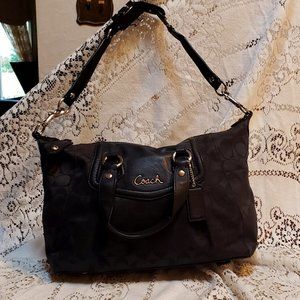 Black Signature Coach shoulder bag or handles.